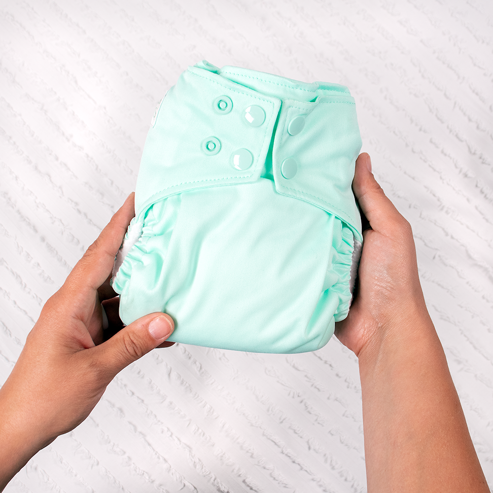 Person holding Nicki's one Size Ultimate Snap All in One Diaper